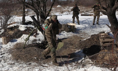 Ukrainian servicemen cover their ears as they fire a mortar toward the Russian position on a frontline not far from Bakhmut in Donetsk, Ukraine.