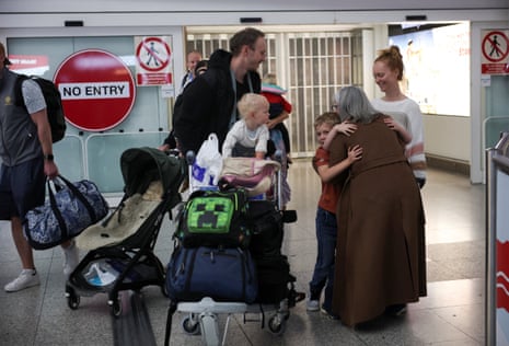 A family from Yorkshire who were living in Dubai greet a relative, as passengers from the first government‑chartered flight for British nationals, which departed from Oman, arrive at London Stansted Airport.