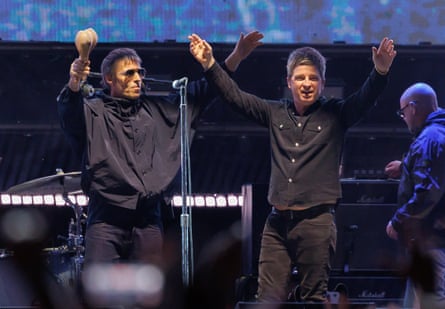 Two men wearing black gesture excitedly on stage