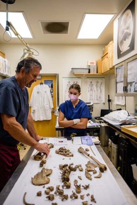Dr Bruce Anderson and anthropology student intern Emma Brewer examine the remains of two unidentified young men from a local cold case who were found murdered outside of Tucson, Arizona more than 20 years ago.