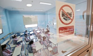 Students attend class at a school in Kuwait City after schools reopened for on-campus learning for the first time in months.