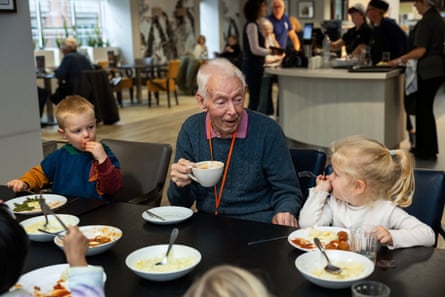 A calming presence … Bill Wall has lunch with toddlers from the nursery.