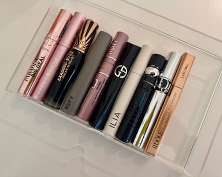 Ten mascaras lined up in a plastic case
