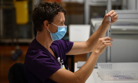 A healthcare worker handles a AstraZeneca Covid-19 vaccine