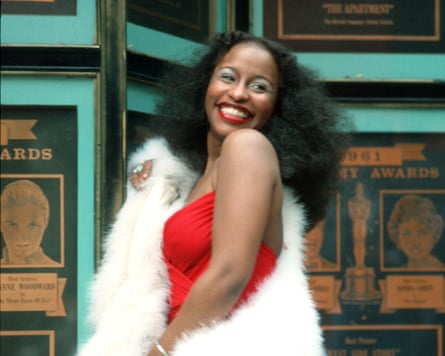 Chaka Khan posing in a fluffy white drape and red dress for a portrait circa 1978.