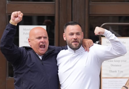 Frederick Doe (right) with his father, both holding their fists in the air in what looks like celebration