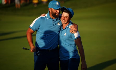 Jon Rahm celebrates with Viktor Hovland on the 18th green