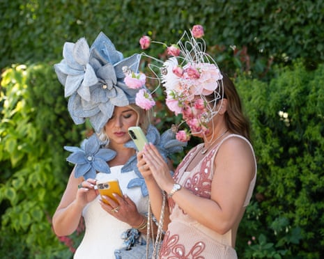 Two racegoers at Ascot, possibly checking the latest odds.