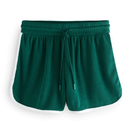 A pair of Next Green Active Tennis Towelling Shorts with white piping on a white background