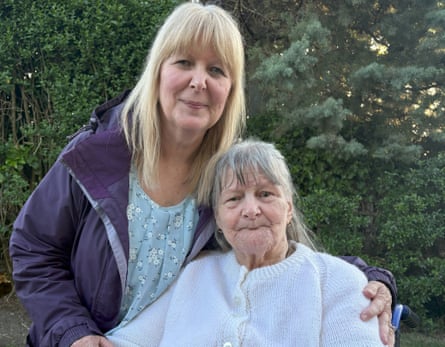 Cathy hugging her mother, Jean, who is sat in a wheelchair