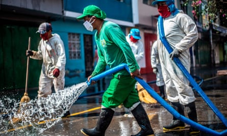 Municipal workers clean and disinfect the surroundings of the Caqueta market in the north of Lima.