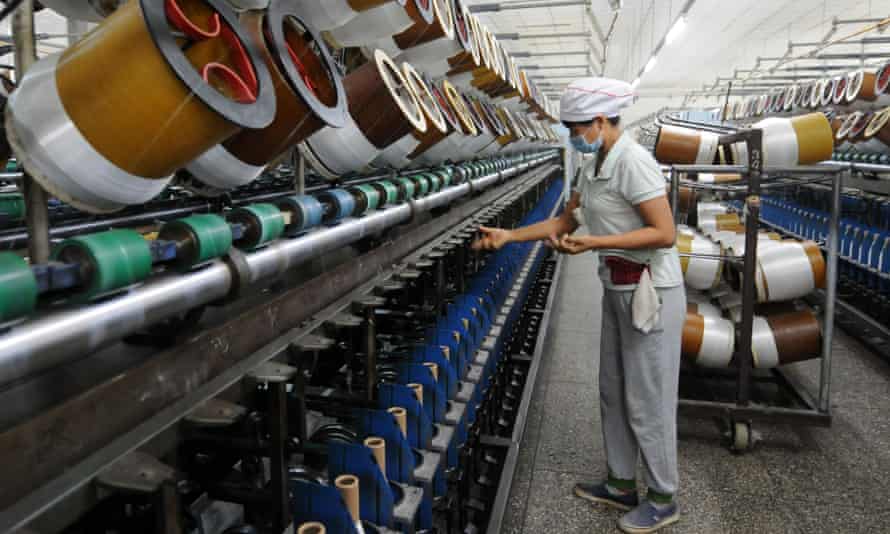 Worker on glass fibre production line in Jiujian, China