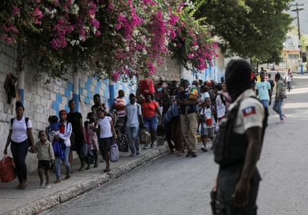 Residents in Port-au-Prince flee their homes after clashes between armed gangs in April.