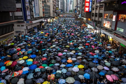 Demonstrators Attend Anti-Government Protest In Hong KongProtester are seen holding up umbrellas while they walk down a street in Hong Kong on August 18, 2019