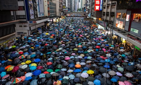 Protesters hold up umbrellas while they walk down a street in Hong Kong in 2019.