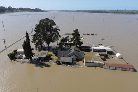 A home is surrounded by flood waters from the Pajaro River after days of heavy rain in Pajaro, California.