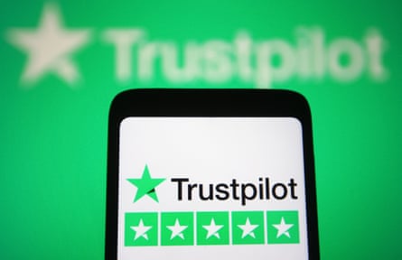 Trustpilot logo on a smartphone and computer screen.