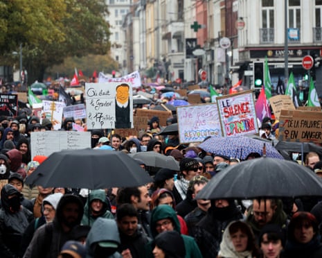 Protestors hold placards with messages about state purchasing power, the protection of public services, and fiscal and social justice, in Lille, northern France
