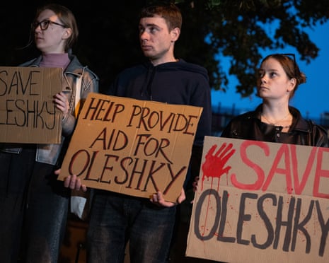 Activists hold cardboard placards reading “Save Oleshky” at a rally for the occupied city