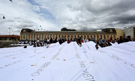 A group of people participate in an artistic intervention at the Plaza de Bolivar in Bogotá, Colombia Tuesday.
