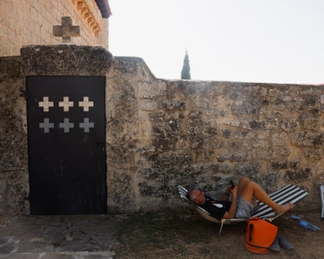 A man rests in the shade as he awaits a solar eclipse in Villalibado, Spain.