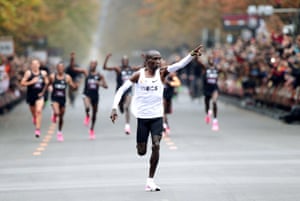 Kipchoge, who previously attempted the feat in Monza in 2017, triumphantly gestures to the crowd as he approaches the finish line.