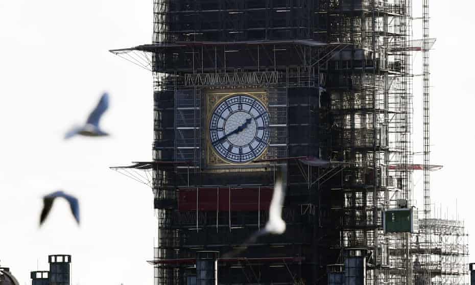 Close up of Big Ben under scaffolding with birds flying in the foreground