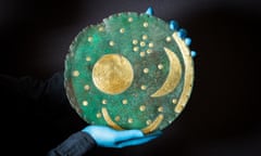 A conservator from the State Musuem of Prehistory in Halle, Germany, holds the Nebra Sky Disc, the world's oldest map of the stars, as it is prepared for display The world of Stonehenge at the British Museum. 