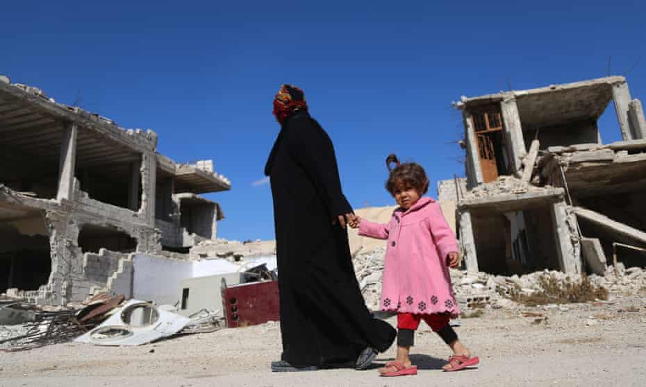 A Syrian woman and her daughter in Al-Nashabiyah in the besieged rebel-held Eastern Ghouta region outside Damascus.