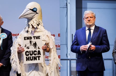 Pownall wears a gannet costume while holding a sign saying ‘End the guga hunt’