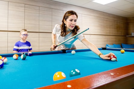 Crown Princess Mary of Denmark plays pool with a patient during a visit to the Willem-Alexander Children’s hospital in Leiden, the Netherlands