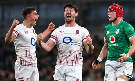 Ben Curry, centre, and Jack van Poortvliet of England celebrate a penalty as Josh van der Flier of Ireland reacts.