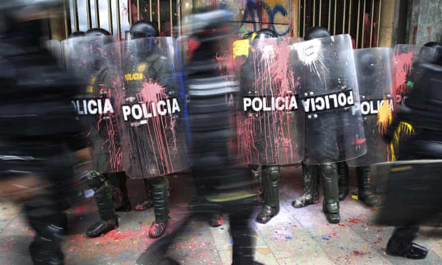 Paint thrown by protesters stains police shields during clashes in Bogota, Colombia