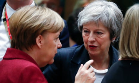 Angela Merkel, the German chancellor (left), speaking to Theresa May at the EU summit