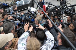 Marion Maréchal-Le Pen surrounded by members of the media pointing cameras and microphones at her