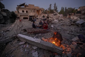 The Al-Naji family prepare to break their fast during the first day of the Muslim holy fasting month of Ramadan amidst the ruins of their family house in Deir al-Balah, Gaza