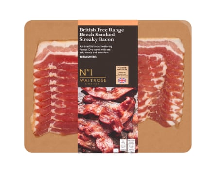 A packet of No 1 British Free Range Beech Smoked Dry Cured Streaky Bacon Rashers. There is a base wood coloured board and the rashers are clearly visible with a branded label wrapped around the middle.