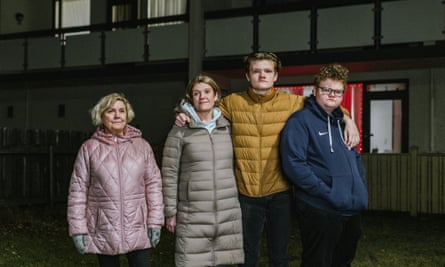Andrea Ævarsdóttir with her mother and two teenage sons outside a block of flats.