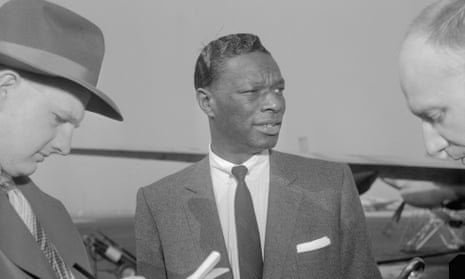 Singer Nat “King” Cole, who was assaulted during an engagement in Birmingham, Ala., is interviewed by newsmen as he stopped at Washington National Airport while en route to Raleigh, North Carolina, to resume his southern tour. 