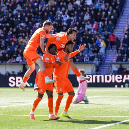 Youssef Chermiti of Rangers is joined in celebration by teammates after putting his side 5-2 ahead at Falkirk