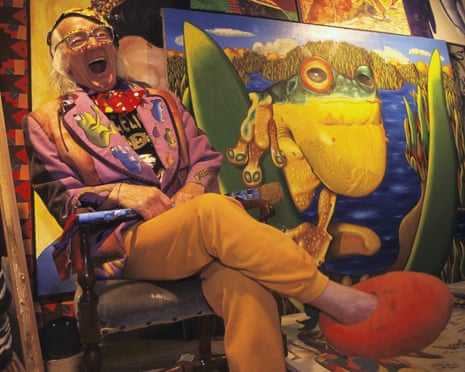 Thornton in brightly painted clothes laughs while sitting in front of a painting of a frog