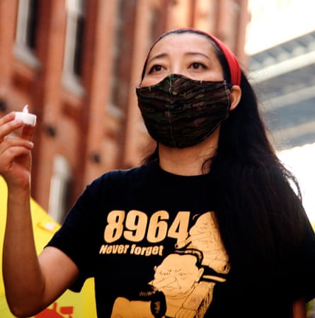 tang holds candle and wears t-shirt that says ‘8964 - never forget’