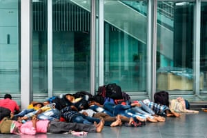 Kolkata, India: Migrant labourers rest outside the departure lounge of the Netaji Subhash Chandra Bose international airport after their flights were cancelled during a day-long state-imposed lockdown as a preventive measure against the Covid-19 coronavirus