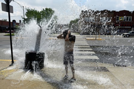 person stands by occurrence hydrant connected sidewalk spraying water