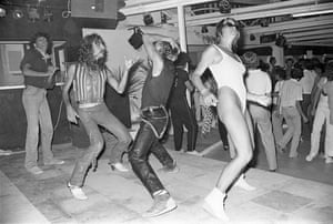 Black-and-white photo of people dancing on a dancefloor, one in a leotard