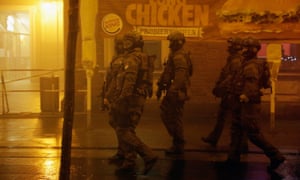 Riot police armed with machine guns patrol the streets in front of Pasing railway station in Munich on Friday.