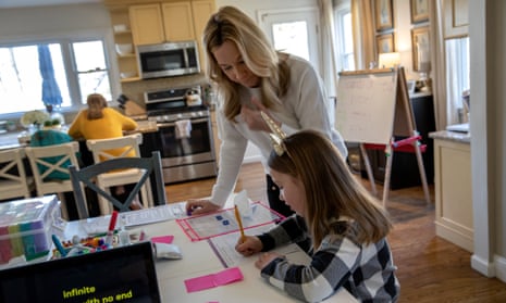 Farrah Eaton helps her two daughters, Elin, left, and Nola with home schooling. 