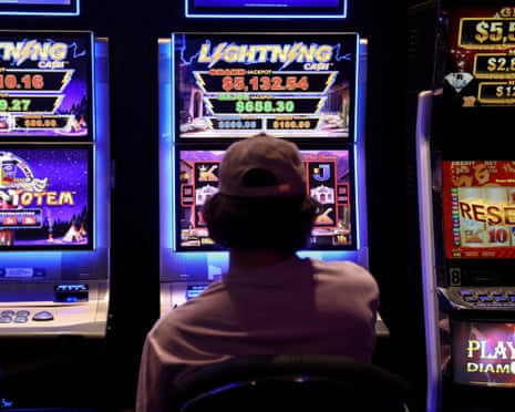 A person gambles on a poker machine at a pub in Sydney