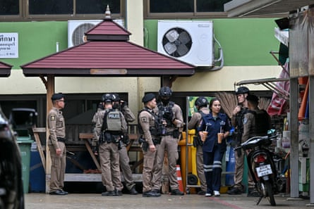 Thai police gather at the scene of a school shooting in Bang Kruai district