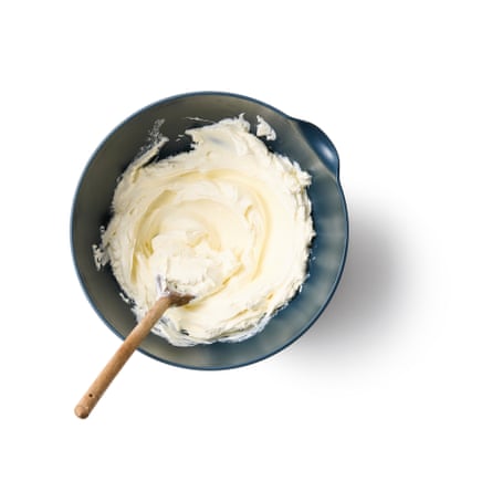 Beating the cream cheese with a wooden spoon.
